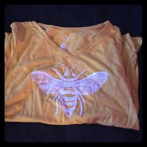 A yellow shirt with a bee on it